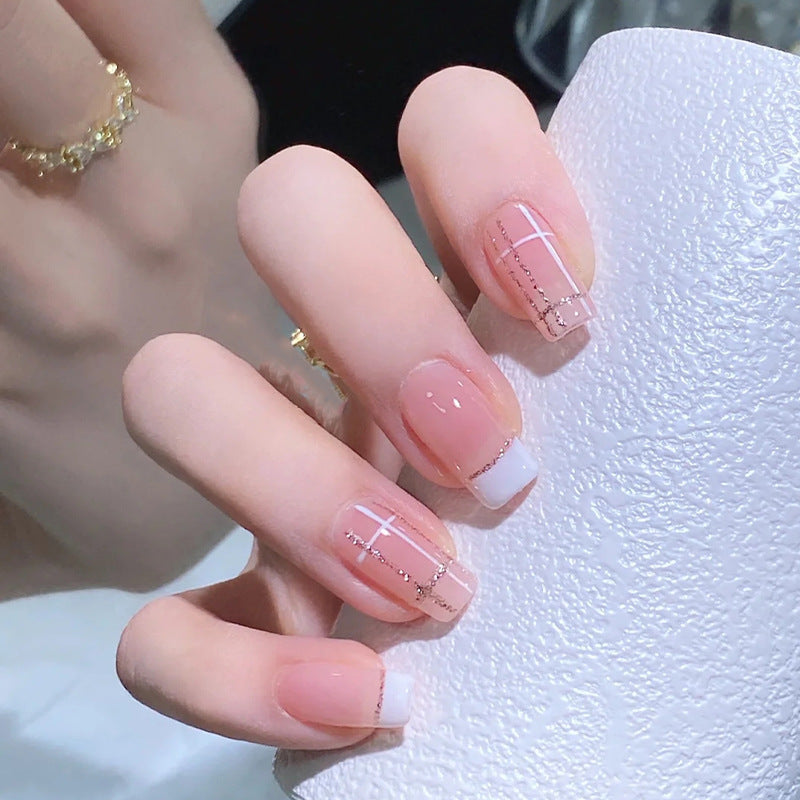 Nail set with elegant French tip and fashionable embellishments Acalora