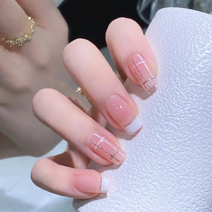 Nail set with elegant French tip and fashionable embellishments Acalora