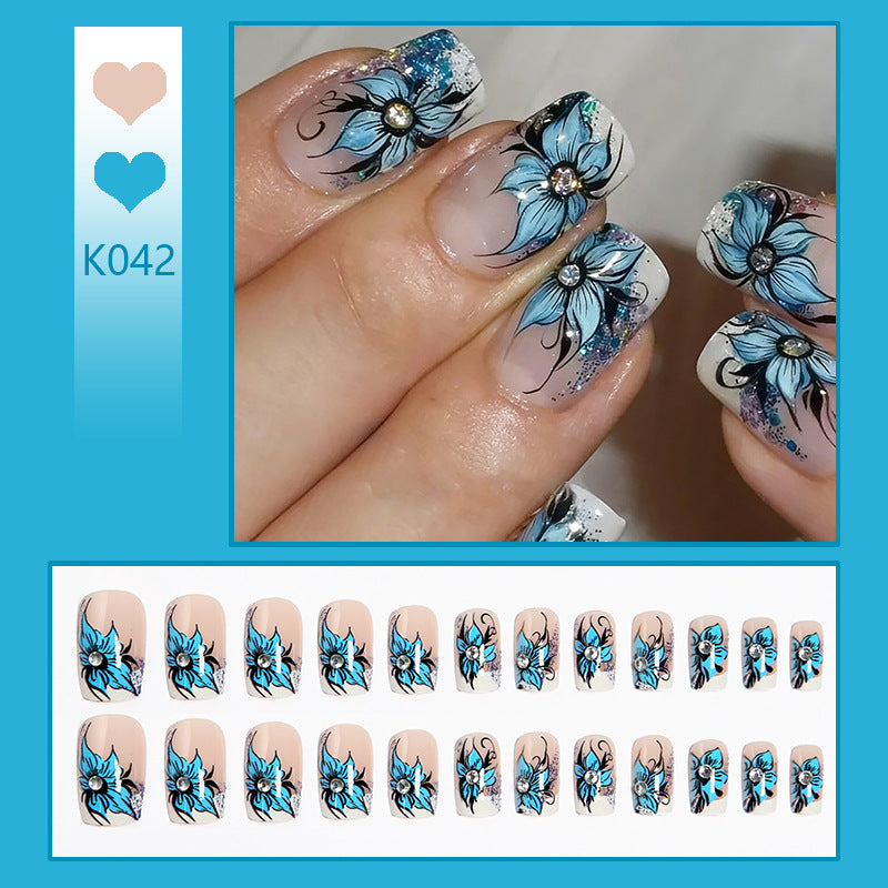 Artificial nail set with intricate floral designs and glitter elements Acalora