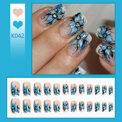Artificial nail set with intricate floral designs and glitter elements Acalora