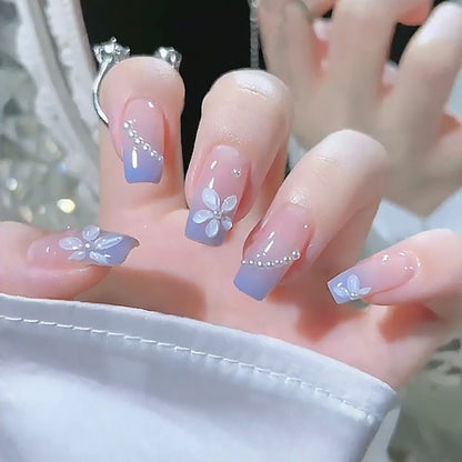Nail set with elegant floral accents and glitter embellishments Acalora