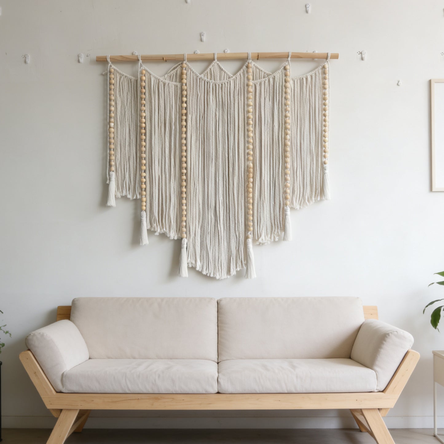 Macramé wall hanging with intricate fringes and wooden beads