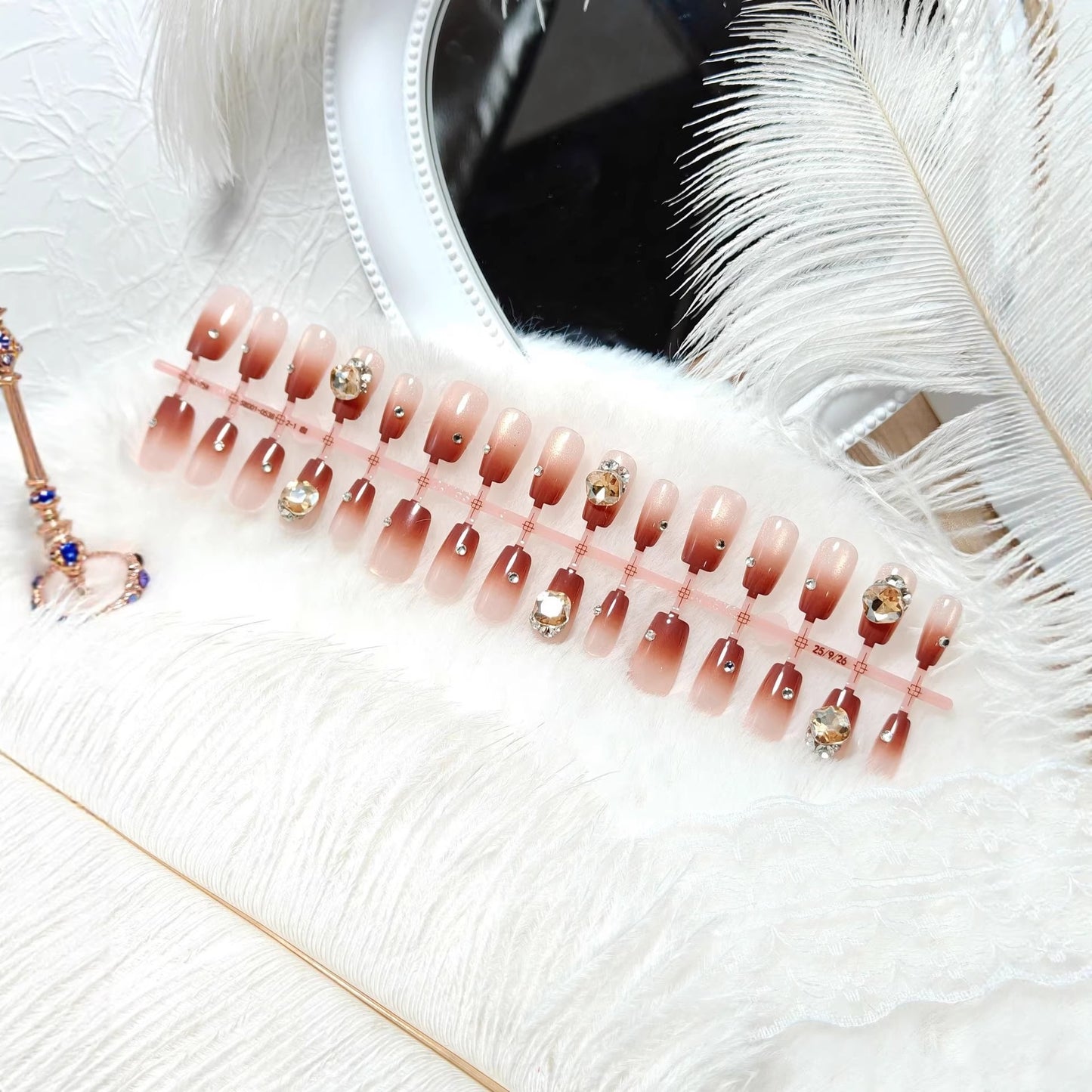 Artificials nails in elegant ombre style with rhinestone embellished applications Acalora