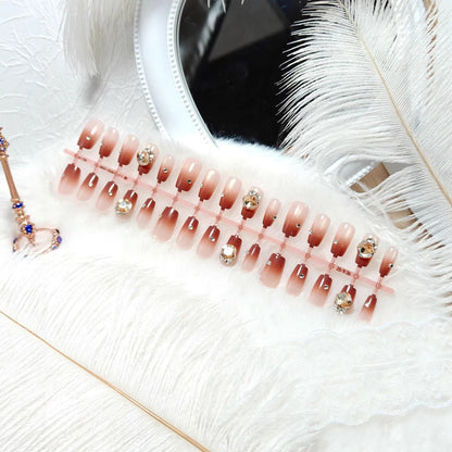 Artificials nails in elegant ombre style with rhinestone embellished applications Acalora