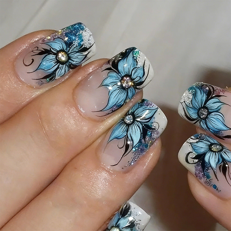 Artificial nail set with intricate floral designs and glitter elements Acalora