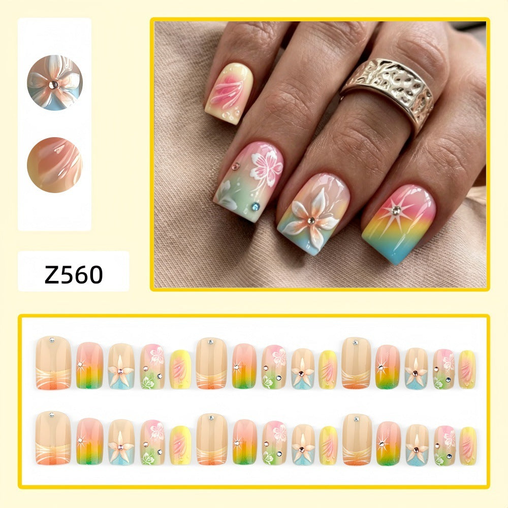 Artificial nails in vibrant floral design with glitter accents Acalora