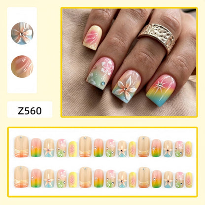 Artificial nails in vibrant floral design with glitter accents Acalora