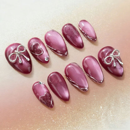 Acrylic nail set with elegant heart and bow decorations Acalora