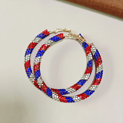 Women's handcrafted crystal pavé hoop earrings with curved tube element and clasp closure Bowlift