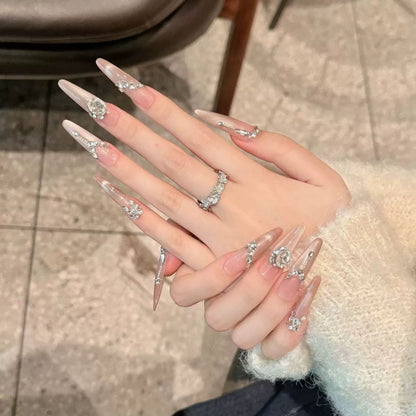 Acrylic nail set with elegant tips and glamorous rhinestone accents Acalora