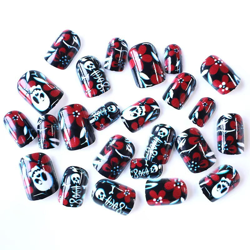 Artificial nail set with creepy skull design and floral accents Acalora