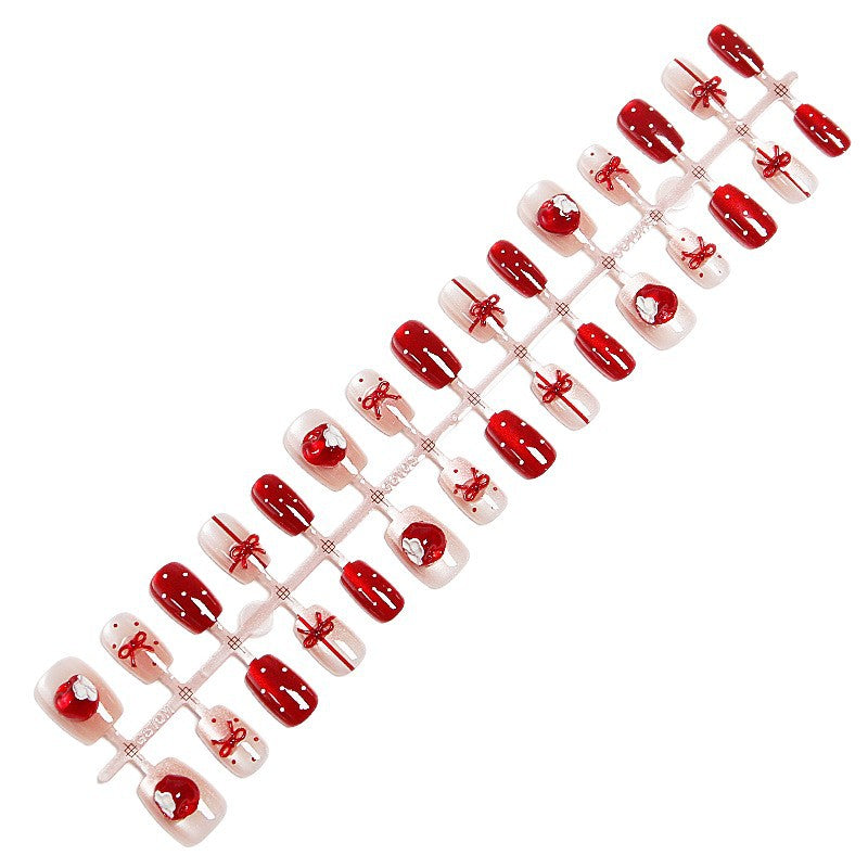 Artificial nail set with festive gift design and elegant glitter accents Acalora