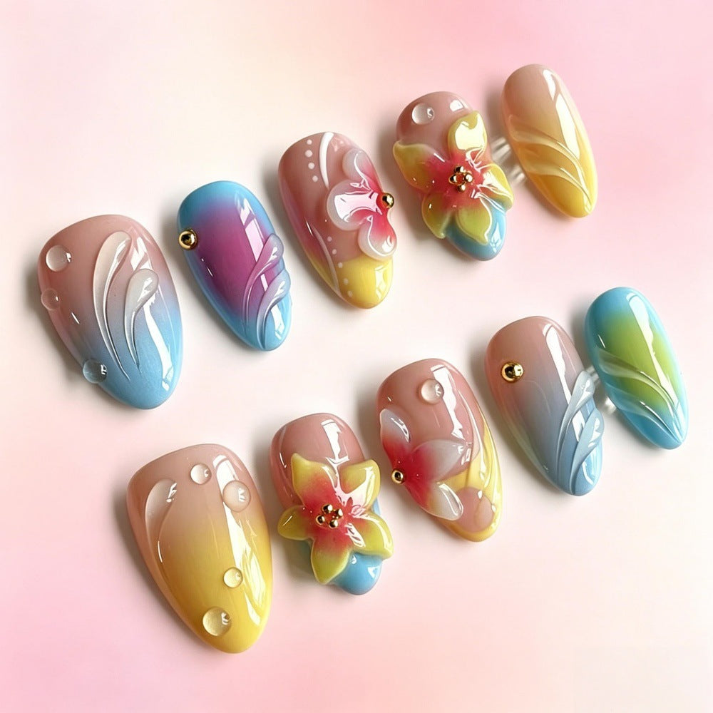 Acrylic nail set with floral elements and colorful accents Acalora