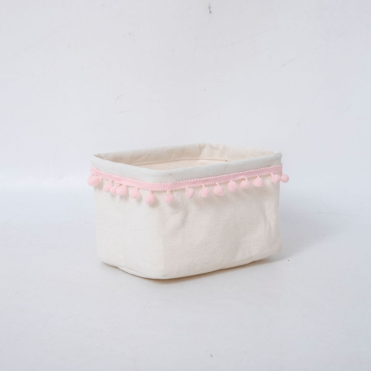 Storage basket with decorative pom-pom trim