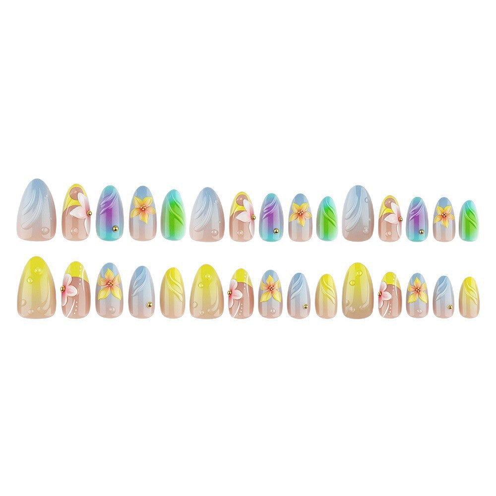 Acrylic nail set with floral elements and colorful accents Acalora