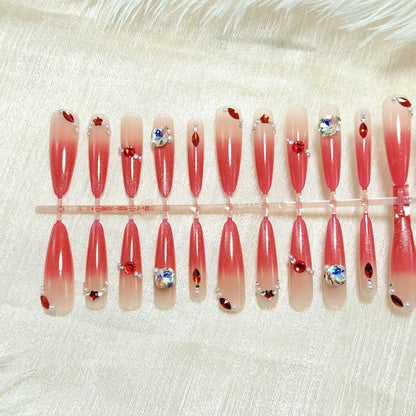 Artificial nails with glamorous glitter and rhinestone embellishments Acalora