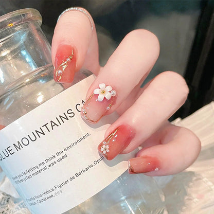Acrylic nail set with elegant floral decorations and glamorous pearl accents Acalora