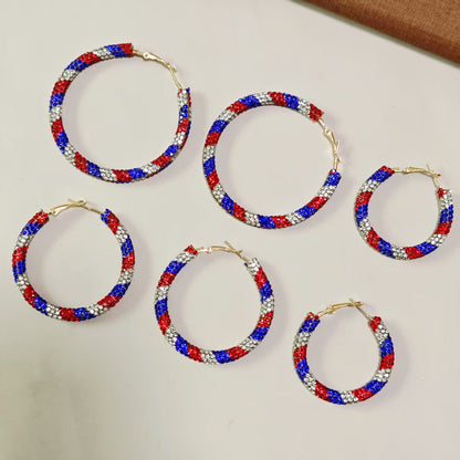 Women's handcrafted crystal pavé hoop earrings with curved tube element and clasp closure Bowlift