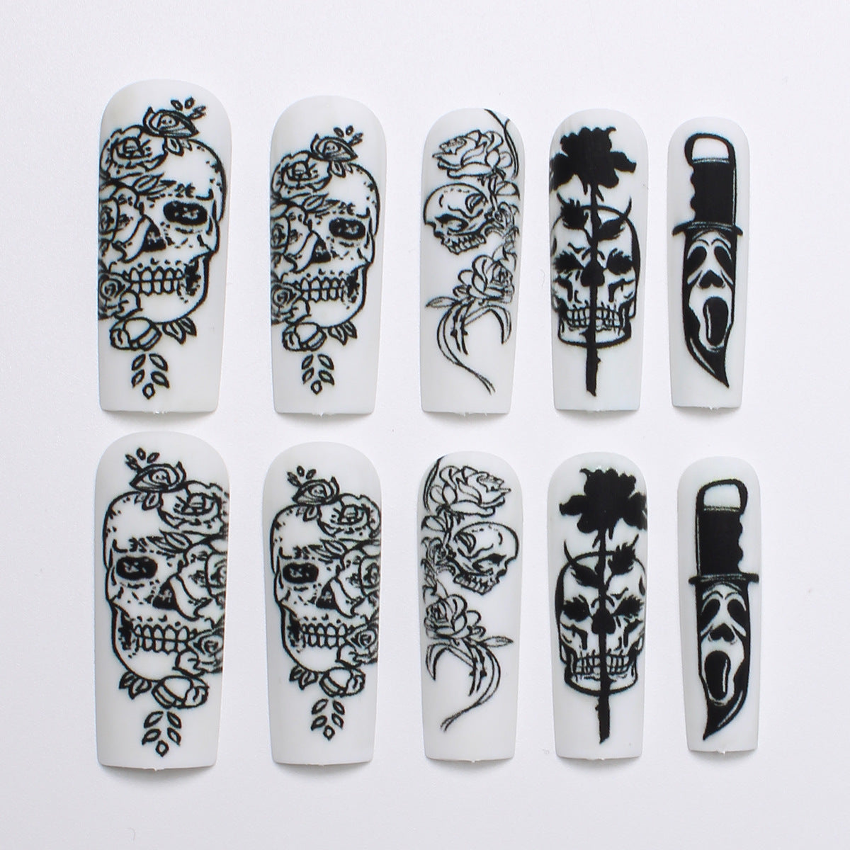 Nail set with spooky skull design and floral motifs Acalora