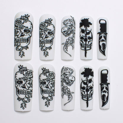 Nail set with spooky skull design and floral motifs Acalora