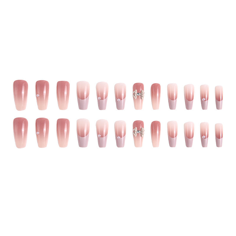Artificial nail set with elegant ombre design and delicate bow embellishments Acalora
