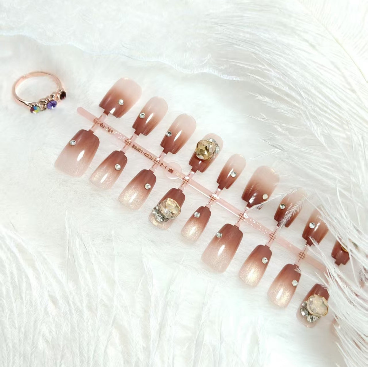 Artificials nails in elegant ombre style with rhinestone embellished applications Acalora