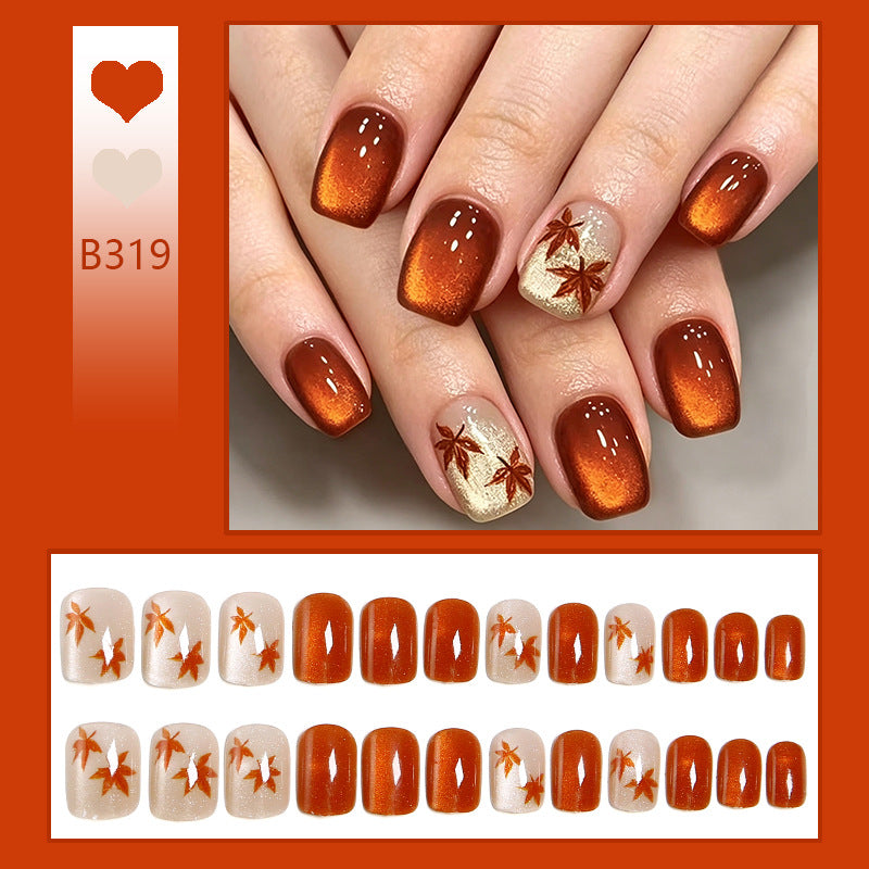 Artificial nails with glamorous ombre design and autumn leaf applications Acalora