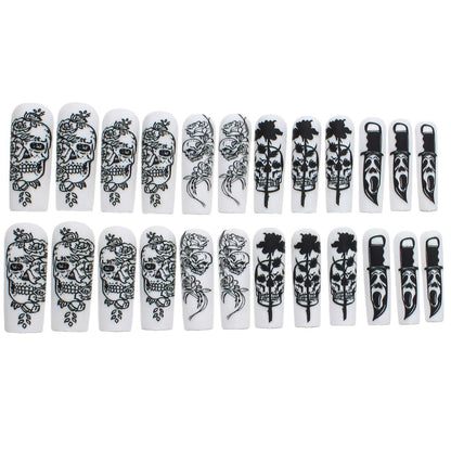 Nail set with spooky skull design and floral motifs Acalora