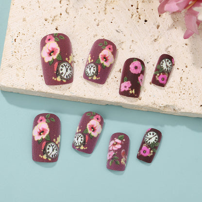 Nail art with floral design and intricate clock motifs Acalora