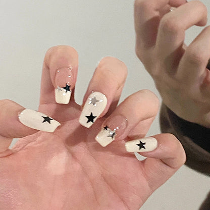 Artificial nail set with glamorous star design and sparkling accents Acalora