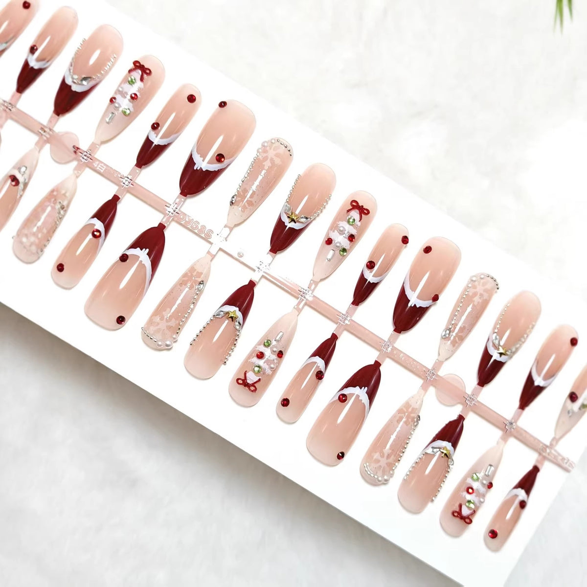 Artificial nails with festive designs and glitter accents Acalora