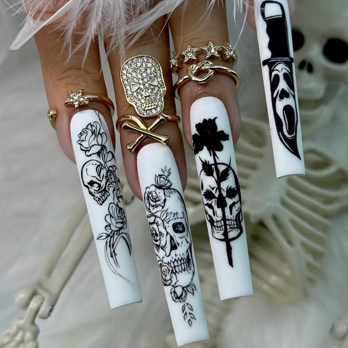 Nail set with spooky skull design and floral motifs Acalora