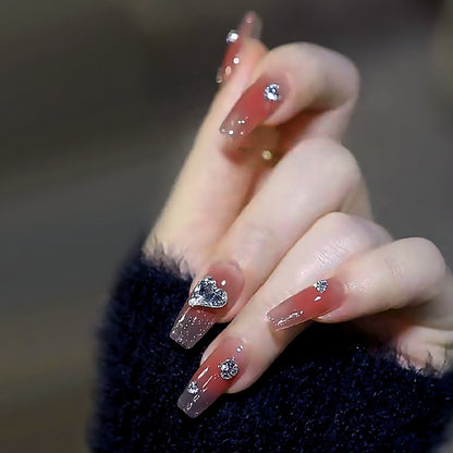 Acrylic nail set with elegant heart and rhinestone decorations Acalora