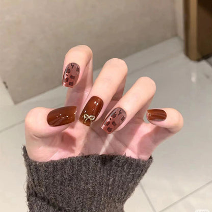 Nail set with elegant leopard pattern and luxurious accents Acalora