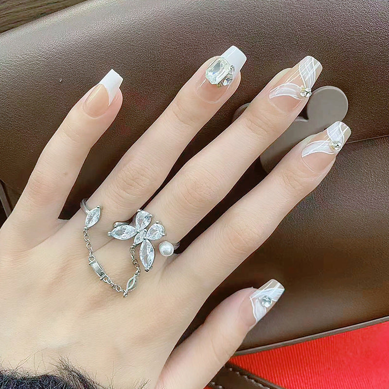 Elegant artificial nail set with delicate decorations and glitter elements Acalora