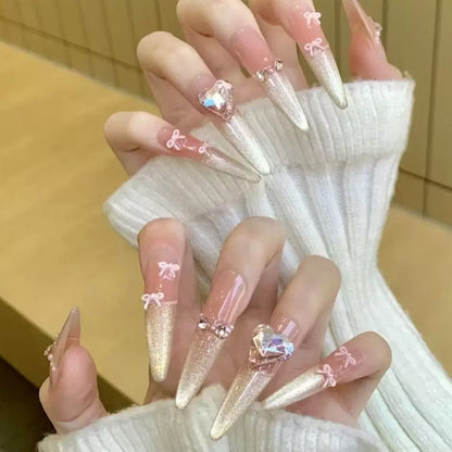 Art nail set with sparkling tips and delicate bow decorations Acalora