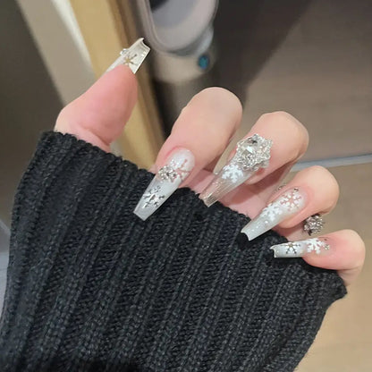 Artificial nail set with frosty snowflake design and sparkling 3D applications Acalora