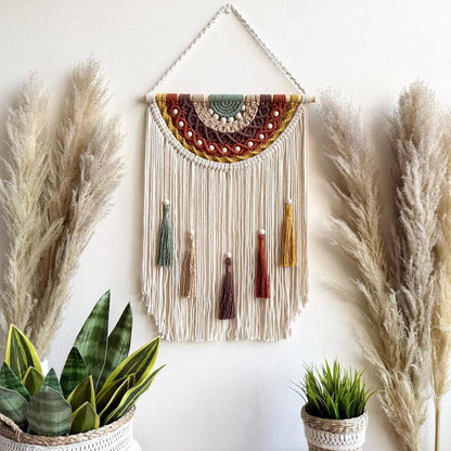 Artistic macrame wall hanging with colorful tassels and decorative elements