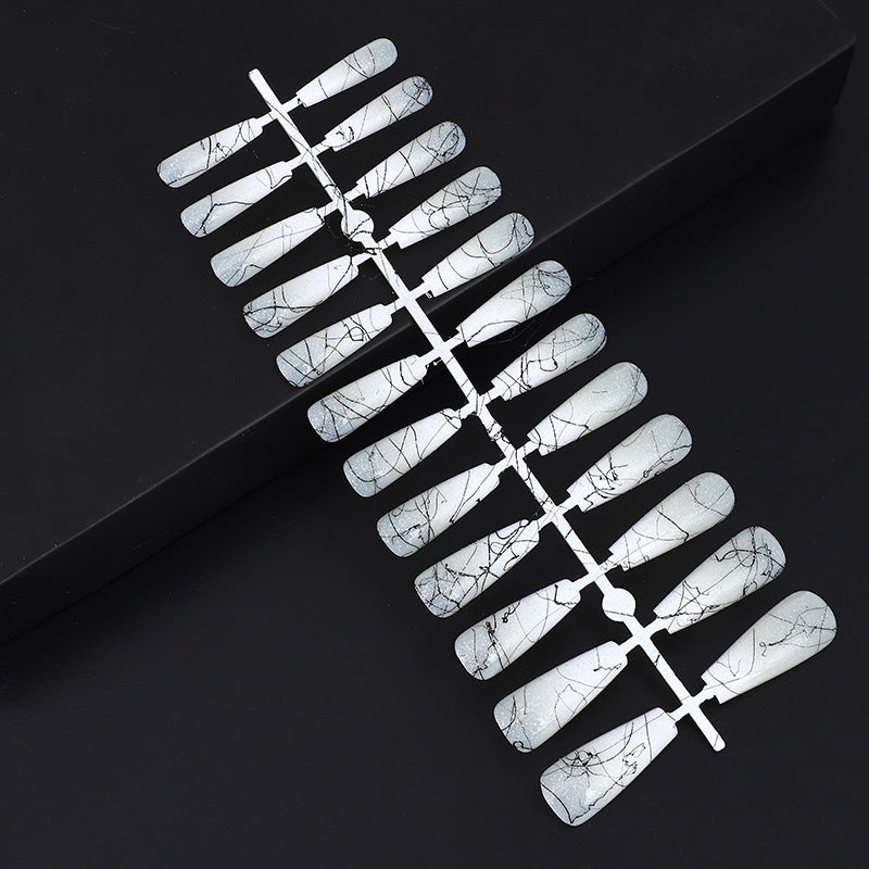 Artificial nails in modern ombre design with marbled accents Acalora