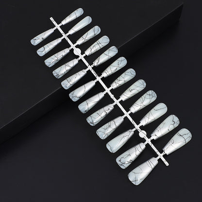 Artificial nails in modern ombre design with marbled accents Acalora