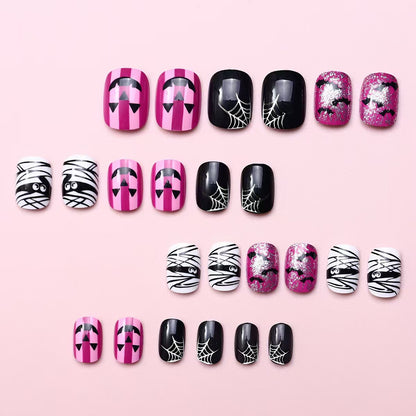 Creative nail art set with Halloween motifs and glitter accents Acalora