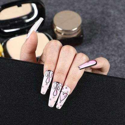 Eye-catching artificial nails with soulful heart design and glamorous accents Acalora