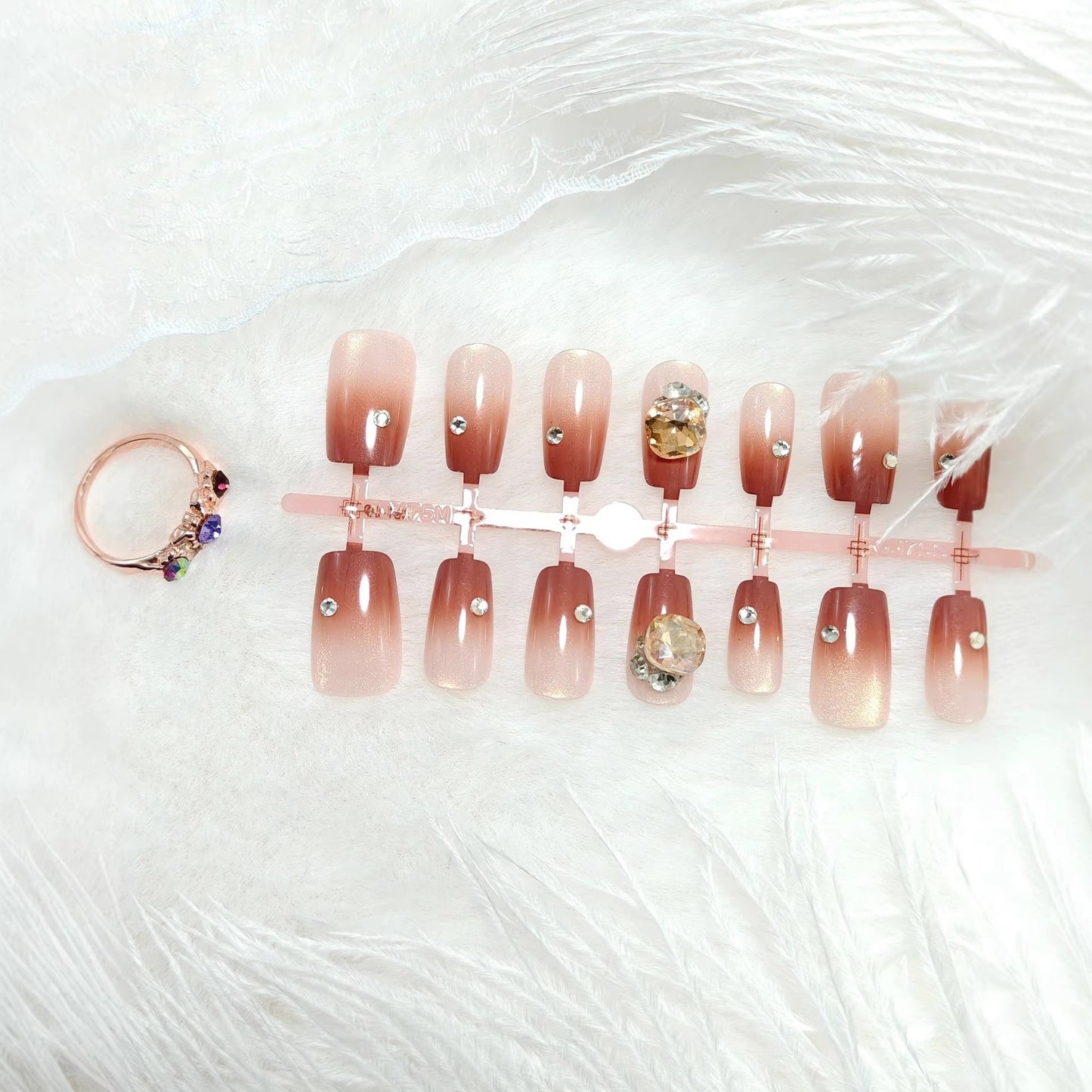Artificials nails in elegant ombre style with rhinestone embellished applications Acalora