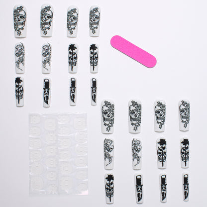 Nail set with spooky skull design and floral motifs Acalora