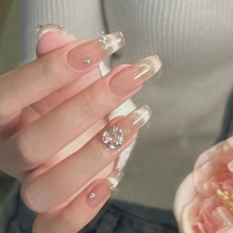 Acrylic nail set with glamorous glitter accents and elegant jewelry embellishments Acalora
