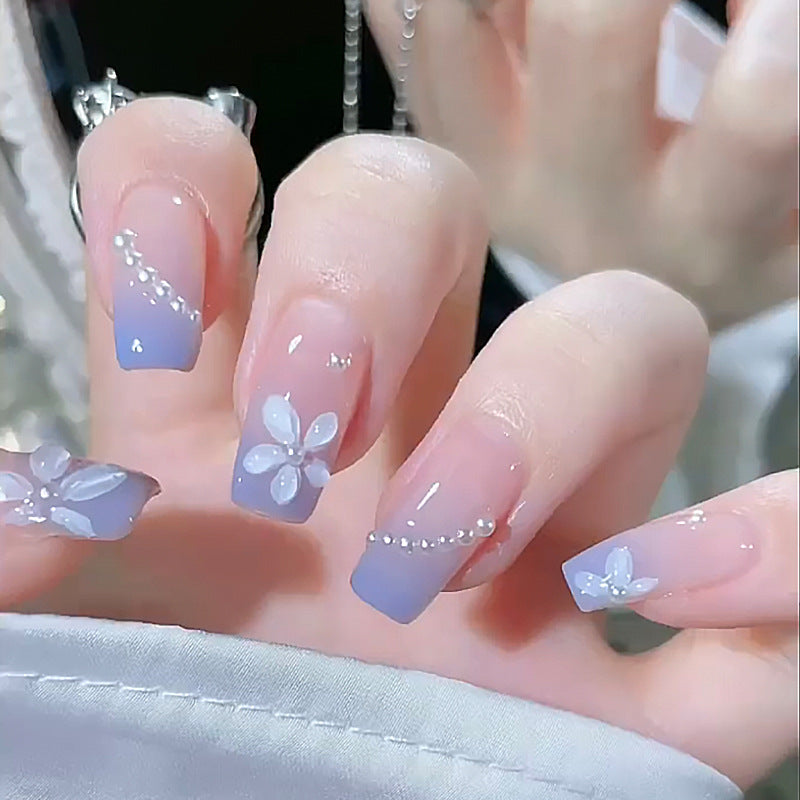 Nail set with elegant floral accents and glitter embellishments Acalora