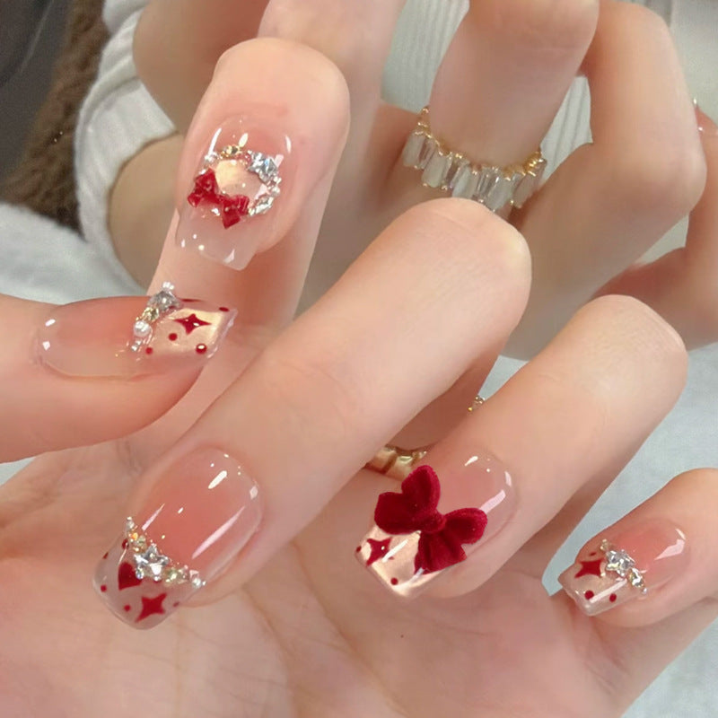 Artificial nail set with festive gift design and elegant glitter accents Acalora