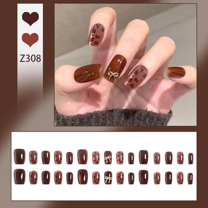 Nail set with elegant leopard pattern and luxurious accents Acalora