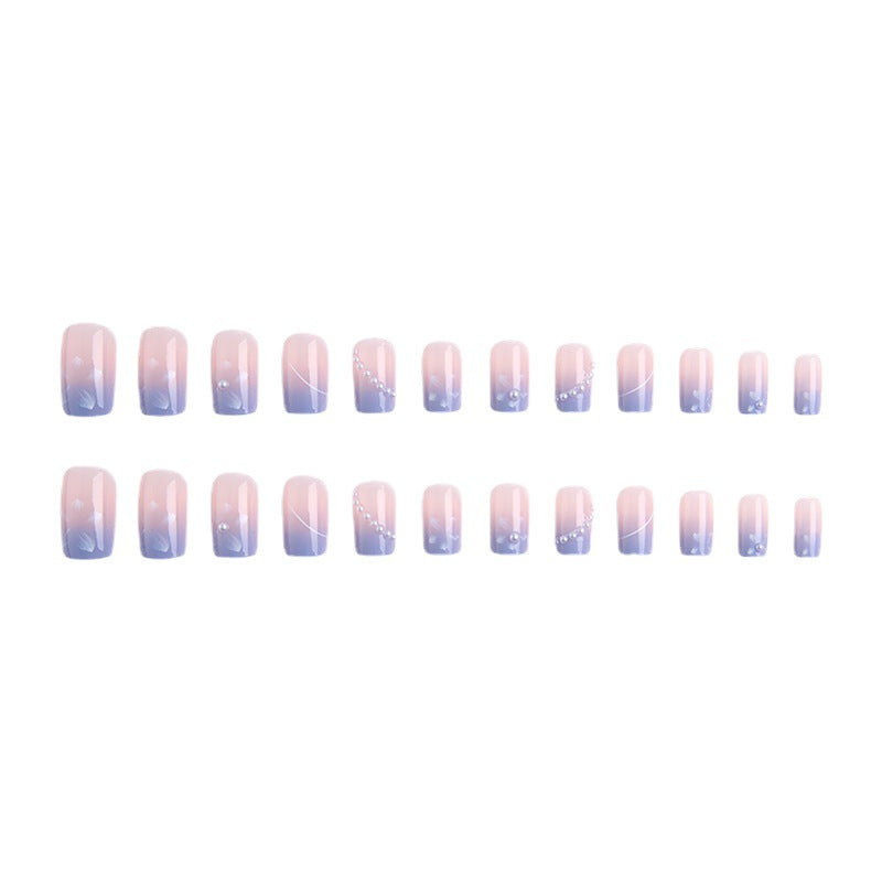 Nail set with elegant floral accents and glitter embellishments Acalora