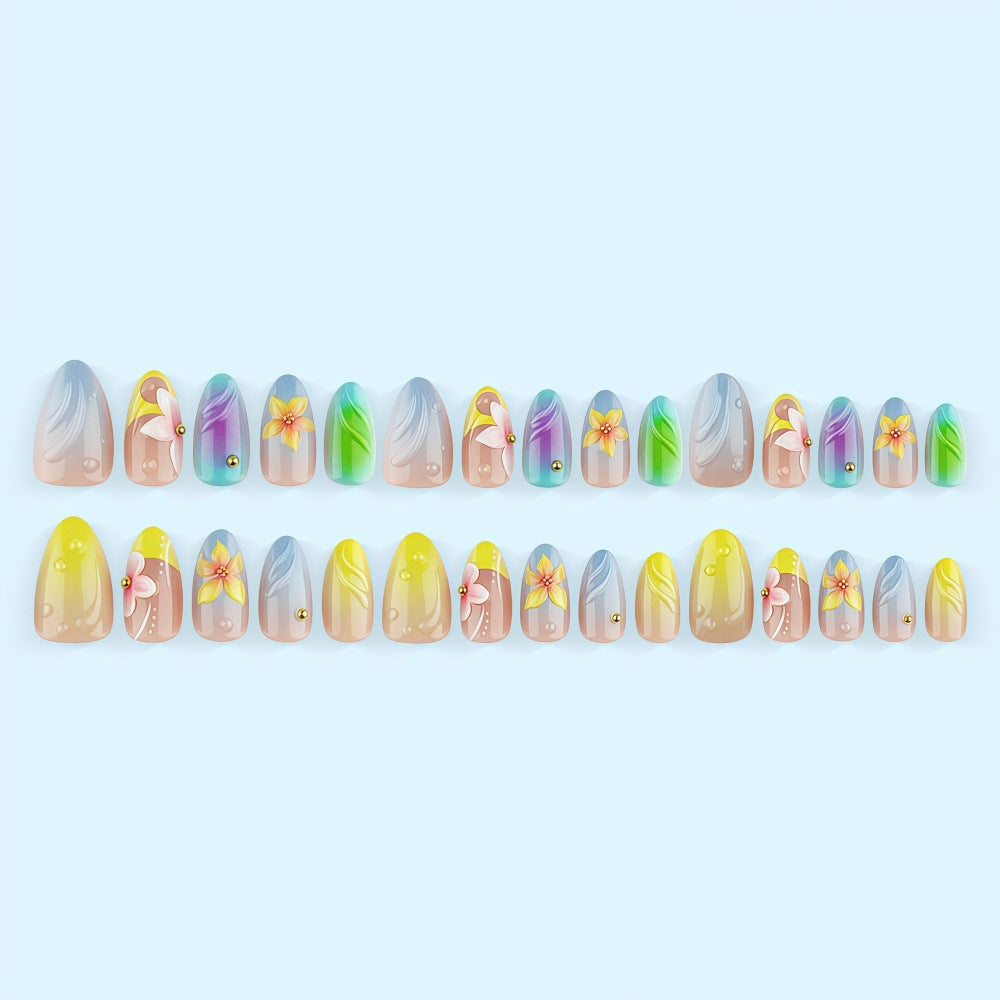 Acrylic nail set with floral elements and colorful accents Acalora